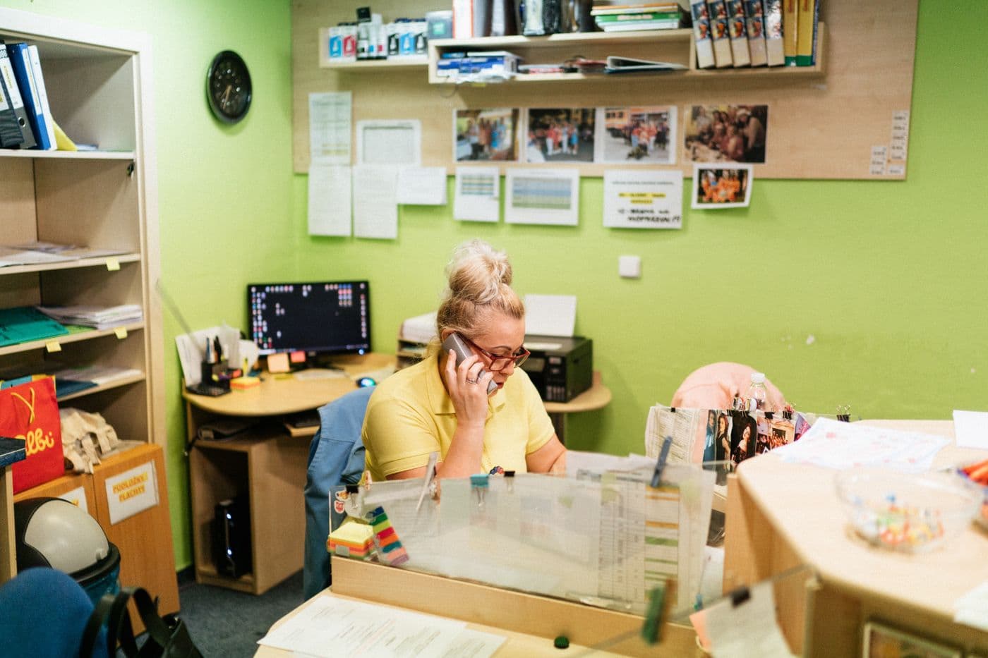 A caregiver taking a call at a reception desk